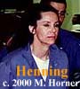 Defendant Linda Henning wearing blue prison uniform and white undershirt.