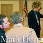 Linda Henning speaks to her attorney, Gary Mitchell, on Monday as Detective Michael Fox points-out areas of interest on a map before the jury.